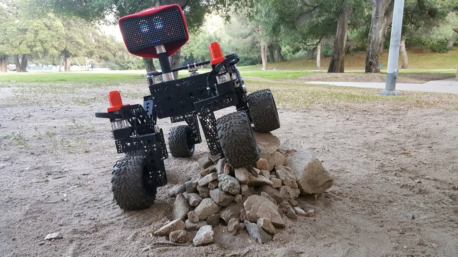 NASA JPL Open Source Rover driving over rocks outdoors