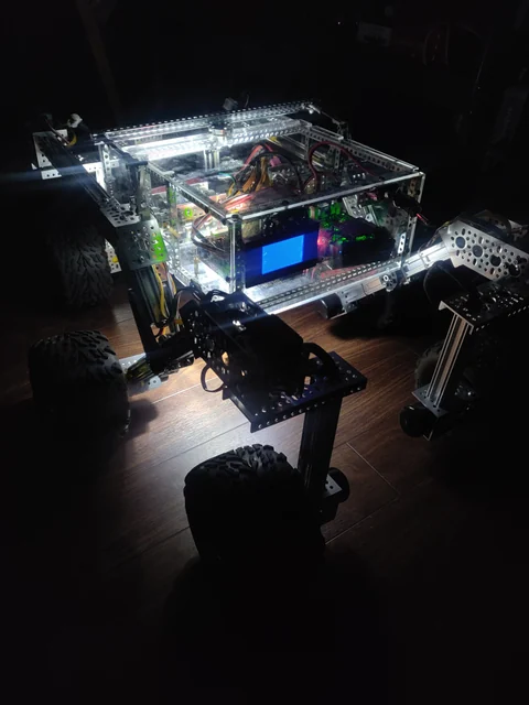 Open Source Rover lit up at night, close-up of the body and rocker-bogie