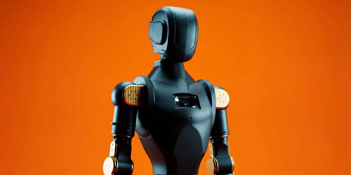 Asimov v1 humanoid, dark shell, against an orange background