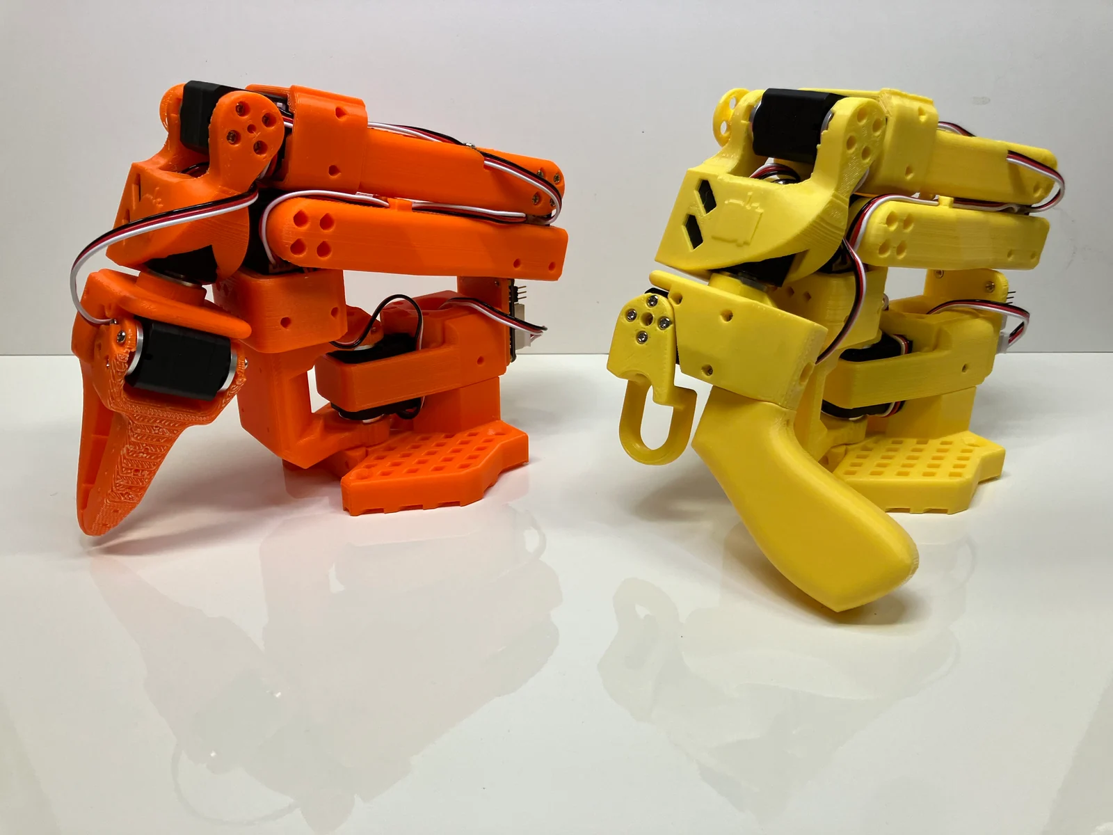 SO-100 leader and follower arms, orange and yellow 3D-printed parts