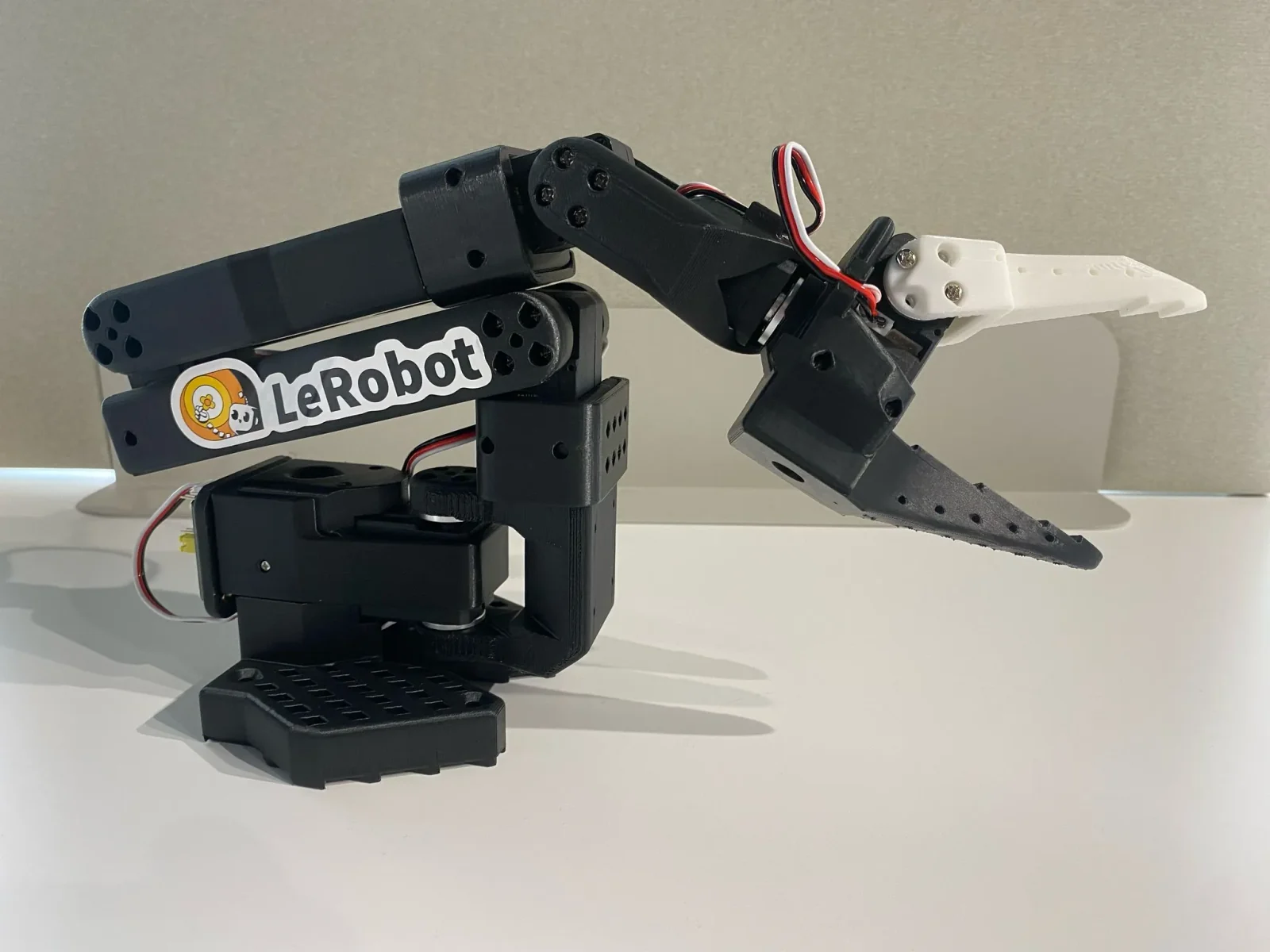 SO-101 follower arm with gripper, black 3D-printed parts
