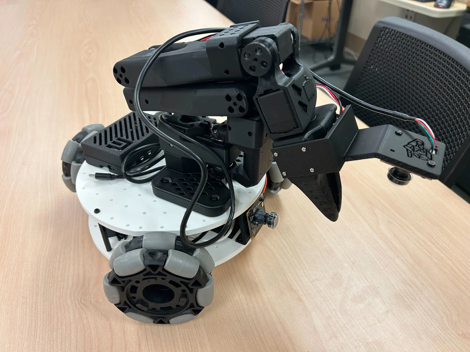 LeKiwi mobile base with an SO-100 arm, omni wheels visible